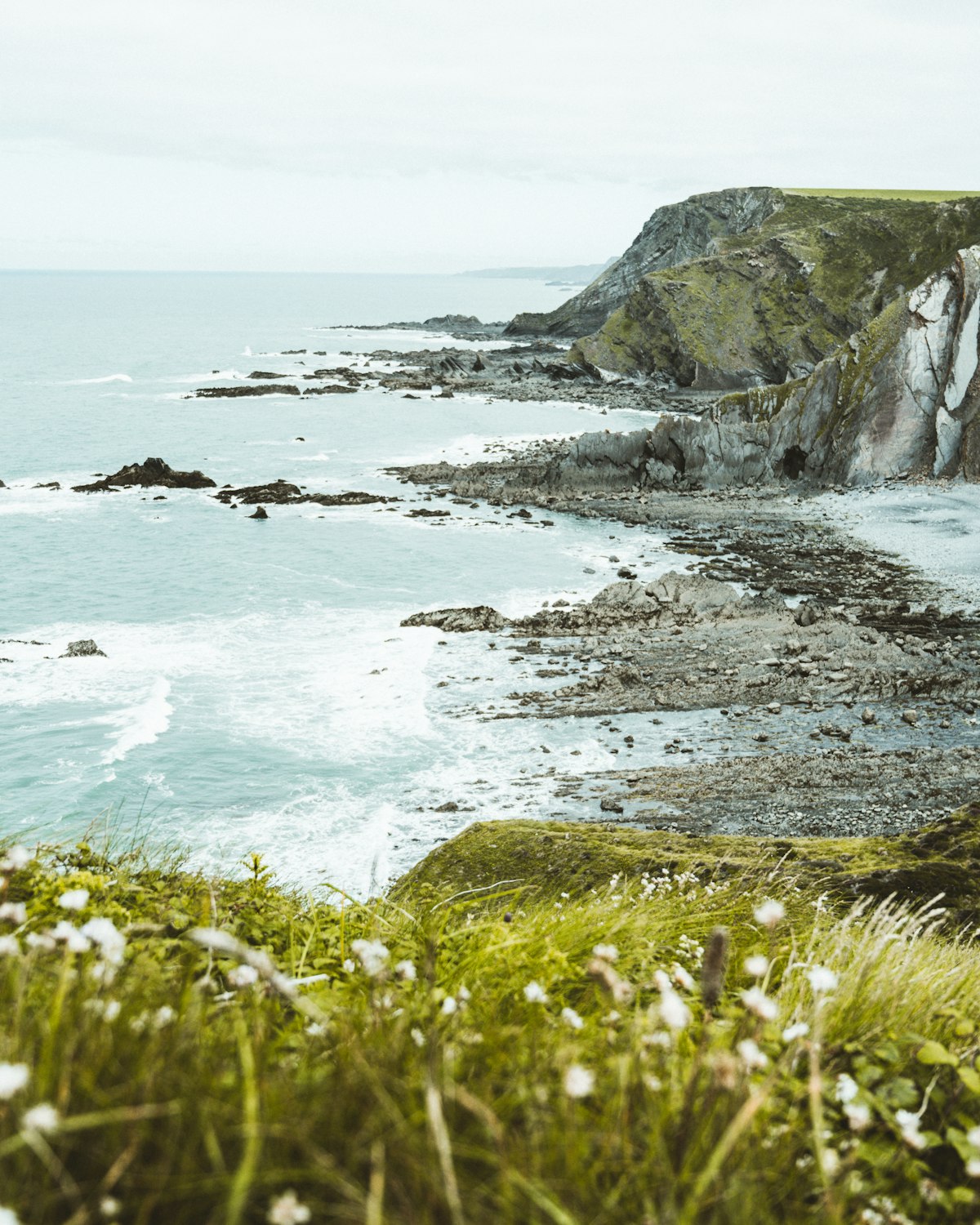 Waves breaking below the cliffs near Porthgale Head