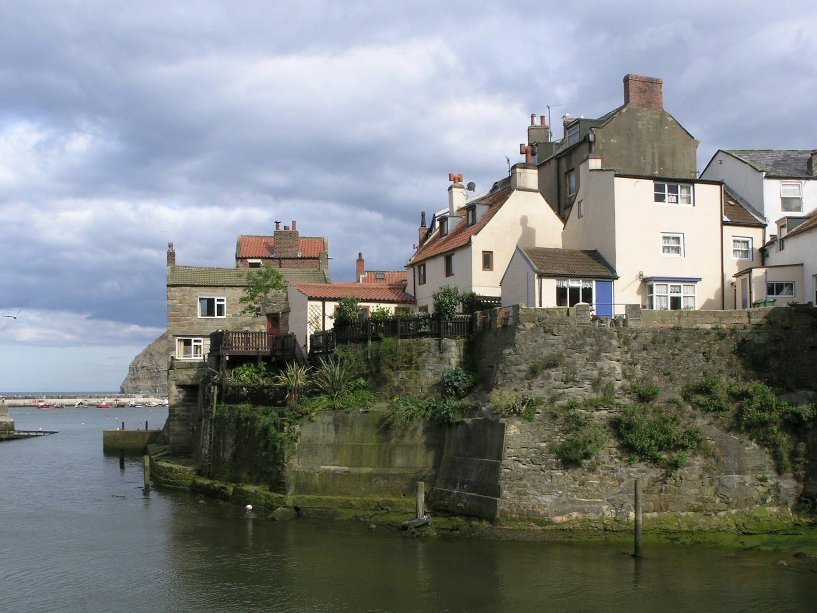 Cottages stacked above the harbour wall at Porthgale
