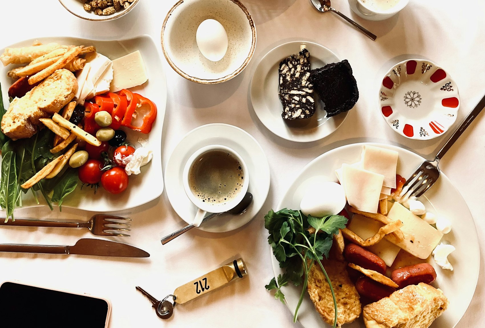 The breakfast table laid with plates, fruit and coffee